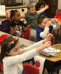 photo of 1st graders participating with storyteller Karen Pillsworth